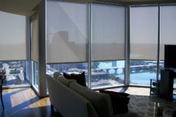 Screen solar shades installed in an apartment overlooking the river