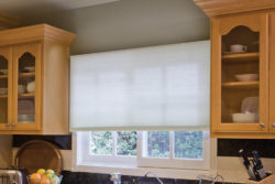 Cellular blinds covering a kitchen window which were installed by Oregon Blinds