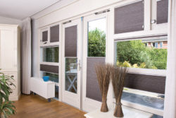 Honeycomb custom blinds open to different levels in this living room