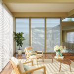The perfect soft light comes through custom sheer shades in a living room