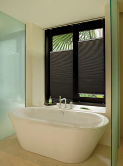 honeycomb custom blinds above this large soaking tub allow for privacy