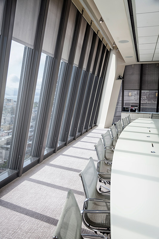 Large screen shade style window blinds are perfect for this large office space with city views