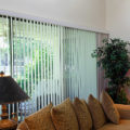 Vertical blinds on a sliding glass door separate the patio and living room in this home