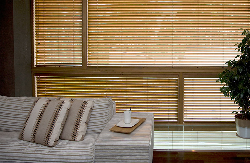 These closed faux wood window blinds help keep this living room a bit cooler